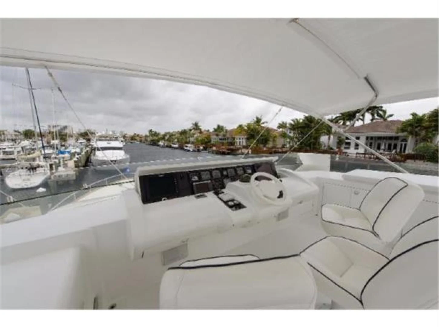 a white yacht in a harbor aboard UTOPIA Yacht for Sale