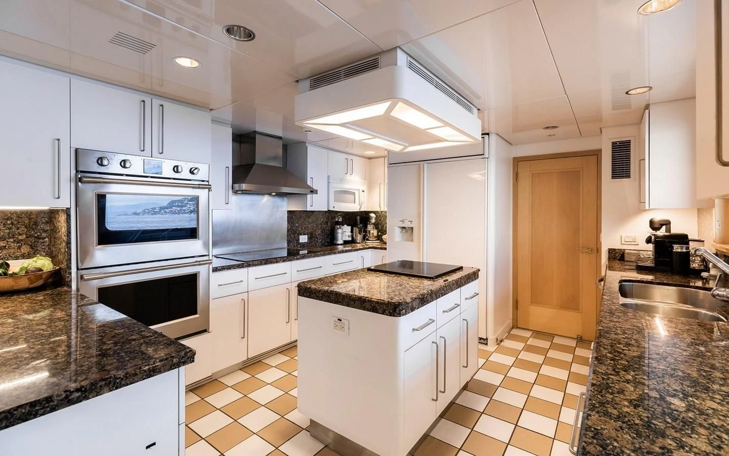 a kitchen with white cabinets aboard SIERRA 2 Yacht for Sale