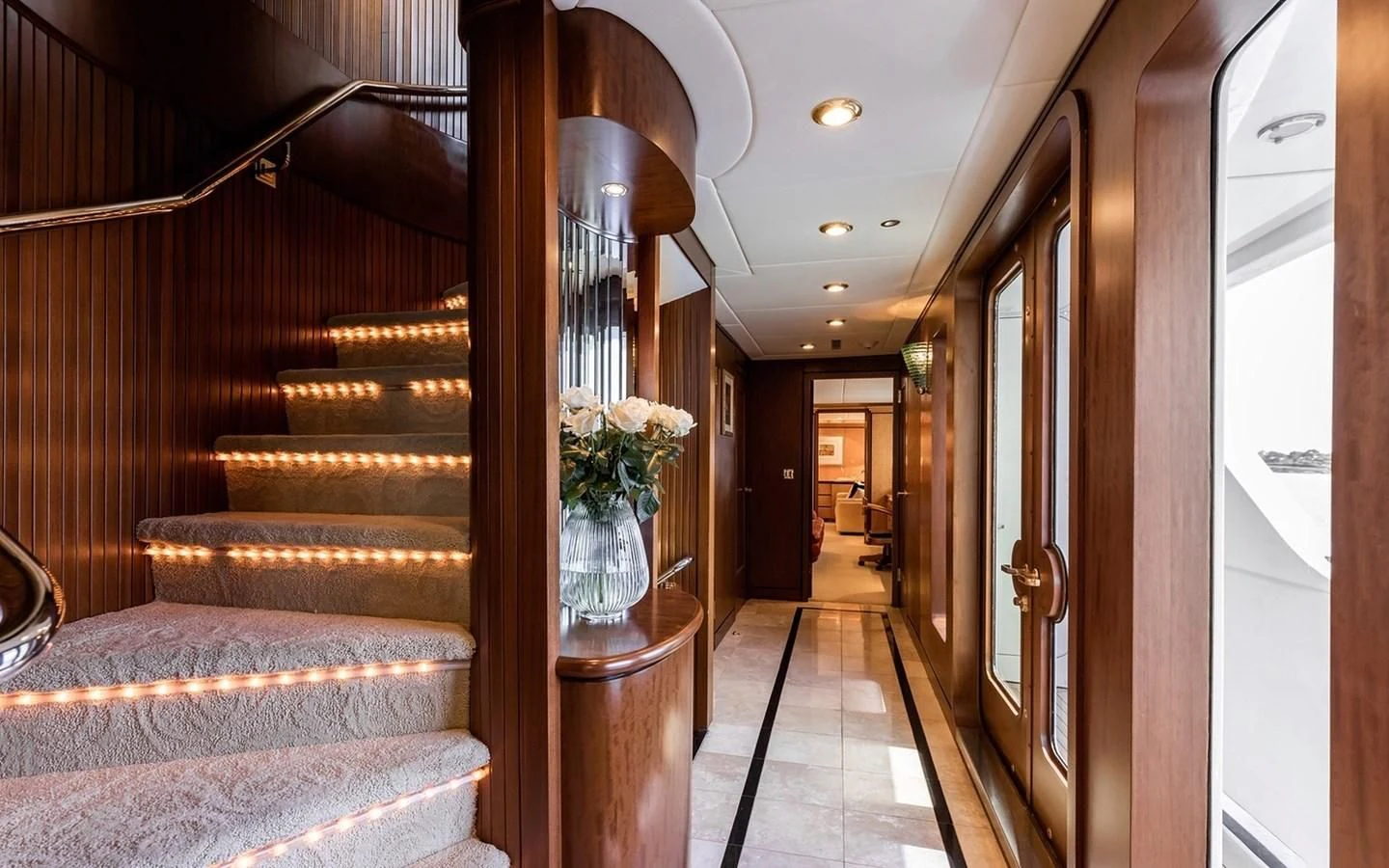 a living room with a wood staircase aboard SIERRA 2 Yacht for Sale