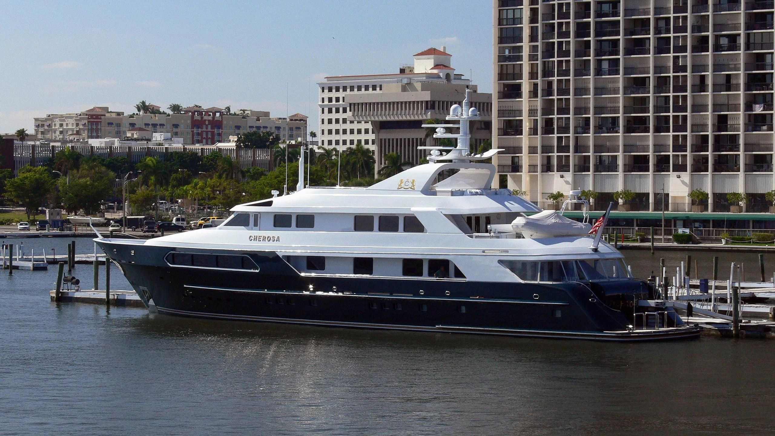 a large white boat in a harbor aboard SIERRA 2 Yacht for Sale