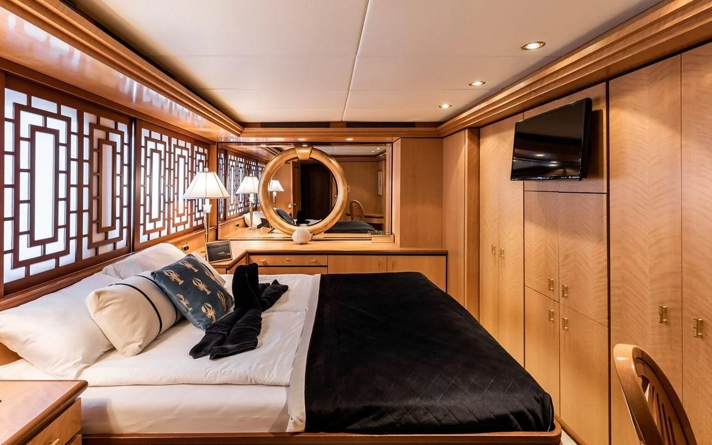 a bedroom with a bed and a mirror aboard SIERRA 2 Yacht for Sale