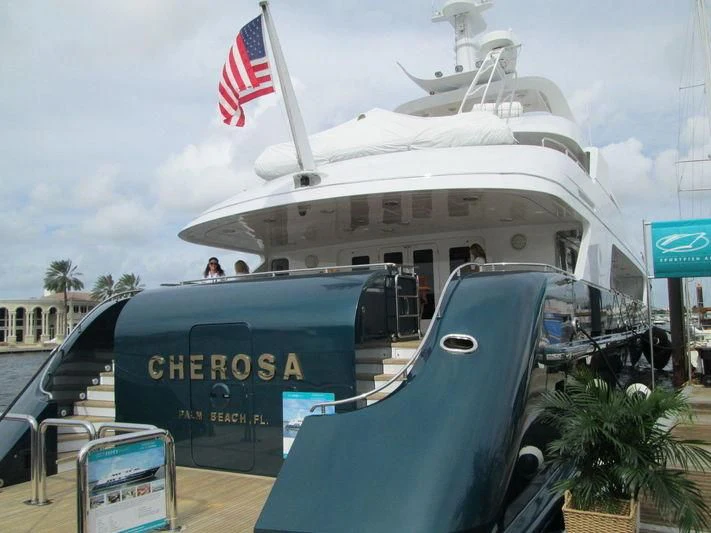 a large boat with a flag on the front aboard SIERRA 2 Yacht for Sale