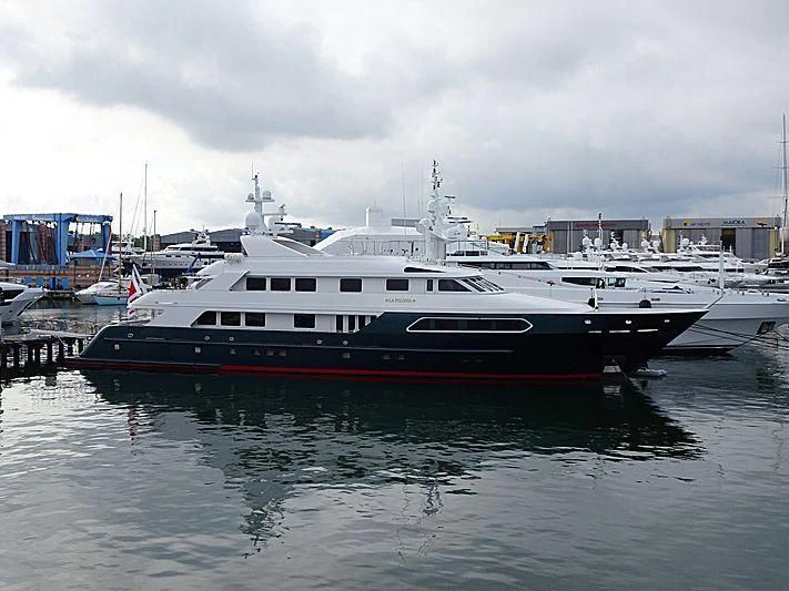 a large boat docked at a pier aboard SIERRA 2 Yacht for Sale