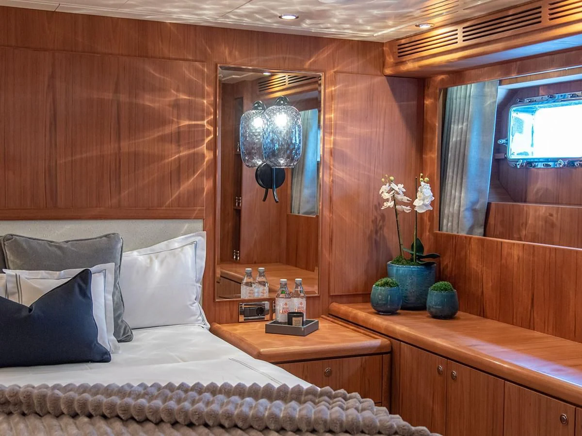 a bed with a white bed spread aboard MOCEAN Yacht for Sale