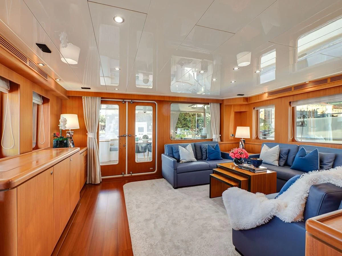 a living room with a blue couch aboard MOCEAN Yacht for Sale