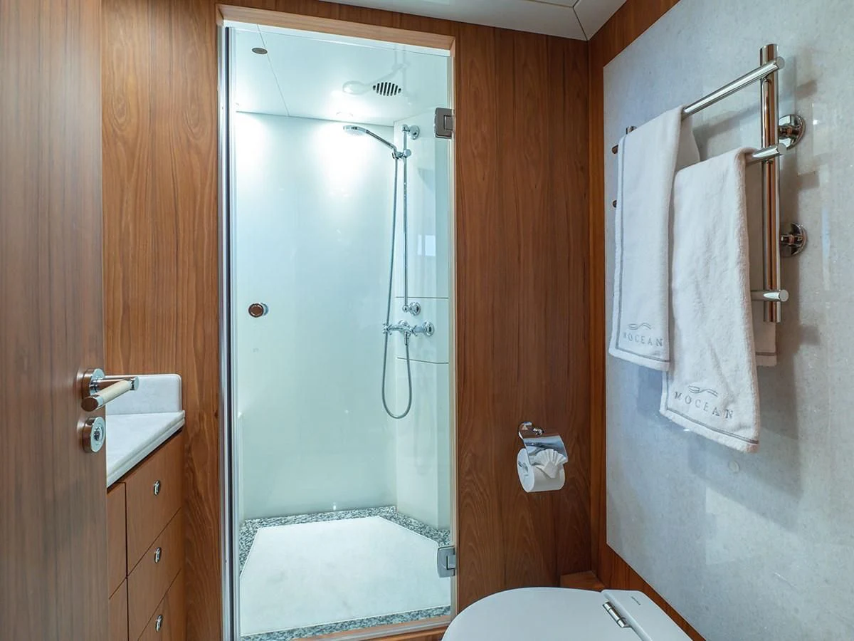 a bathroom with a shower unit and sink aboard MOCEAN Yacht for Sale