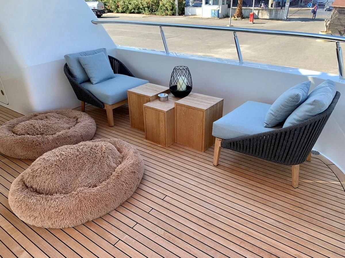 a couch and a table on a deck aboard MOCEAN Yacht for Sale