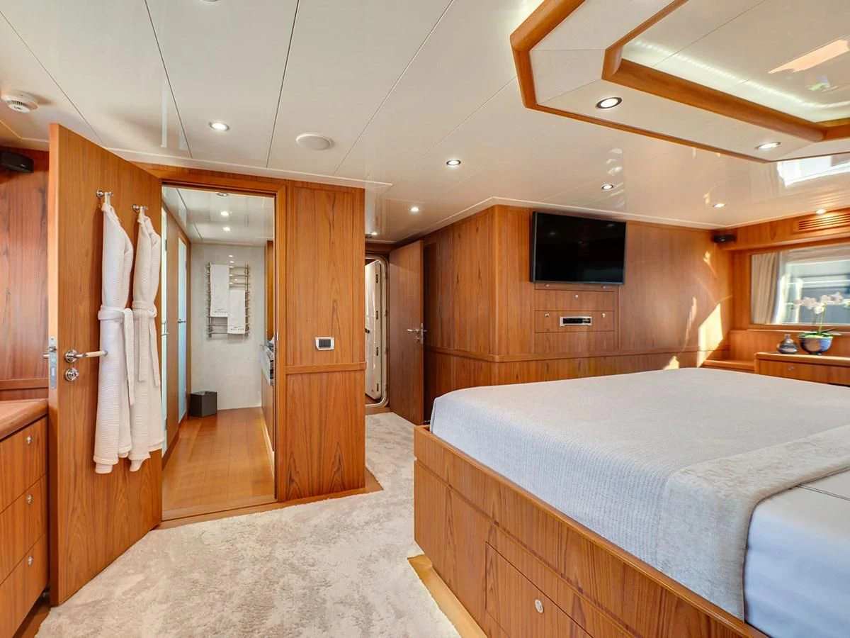 a bedroom with a bed and a closet aboard MOCEAN Yacht for Sale