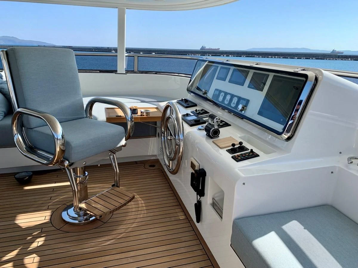 a chair next to a desk with a computer on it aboard MOCEAN Yacht for Sale