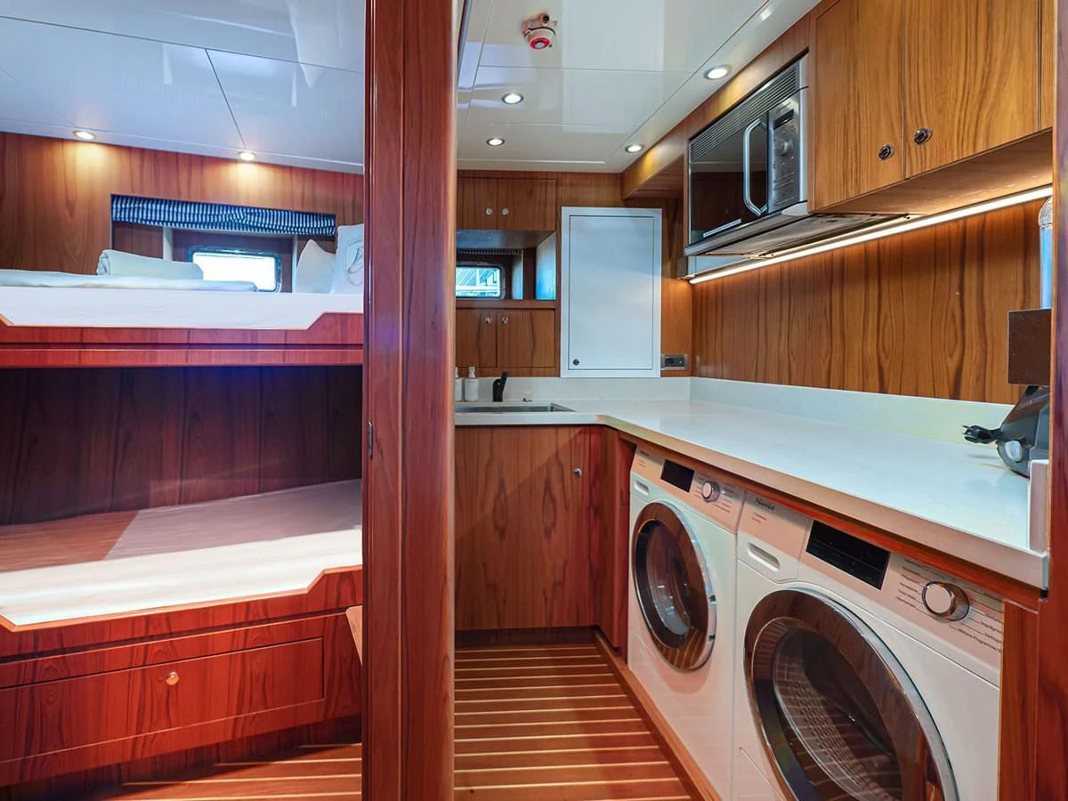 a kitchen with wooden cabinets aboard MOCEAN Yacht for Sale