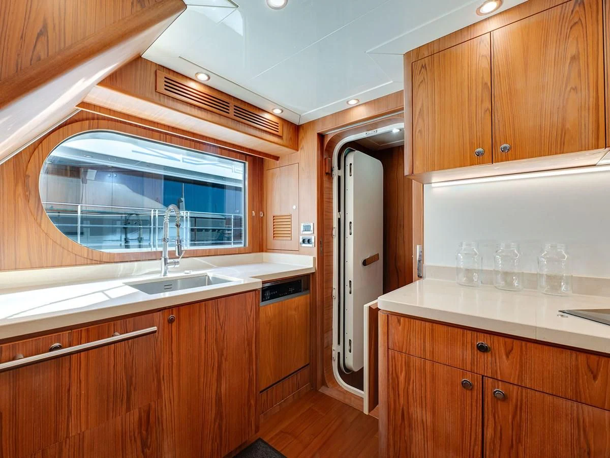 a kitchen with wooden cabinets aboard MOCEAN Yacht for Sale