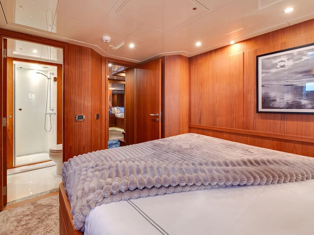a bedroom with a bed and a television aboard MOCEAN Yacht for Sale