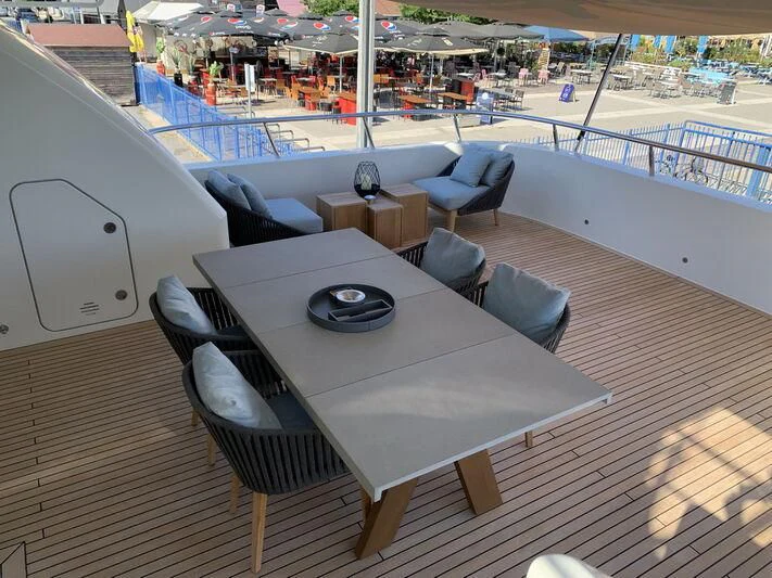 a table on a deck aboard MOCEAN Yacht for Sale