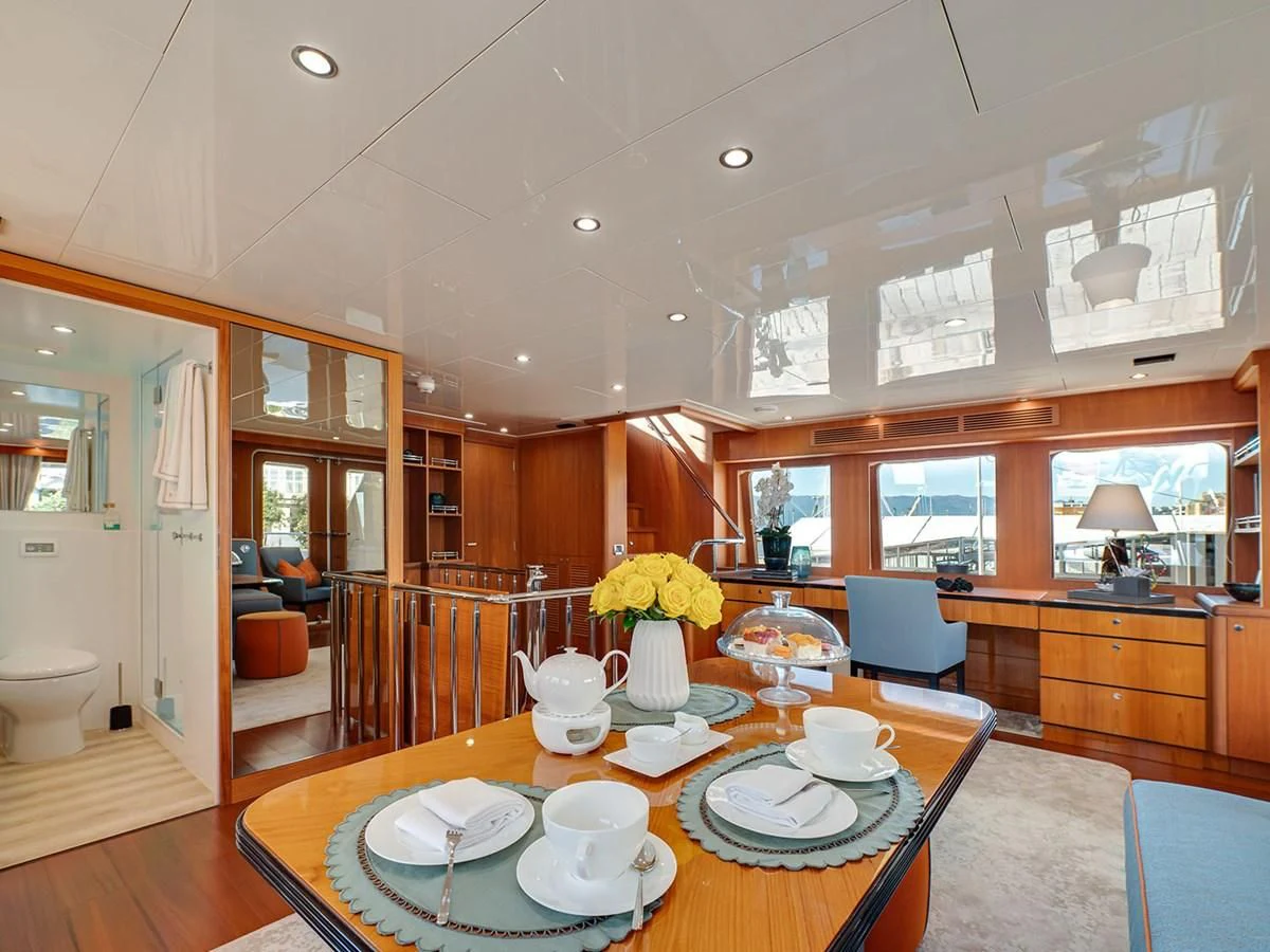 a large kitchen with a dining table aboard MOCEAN Yacht for Sale
