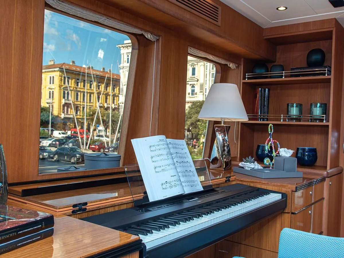 a piano with a book on it aboard MOCEAN Yacht for Sale