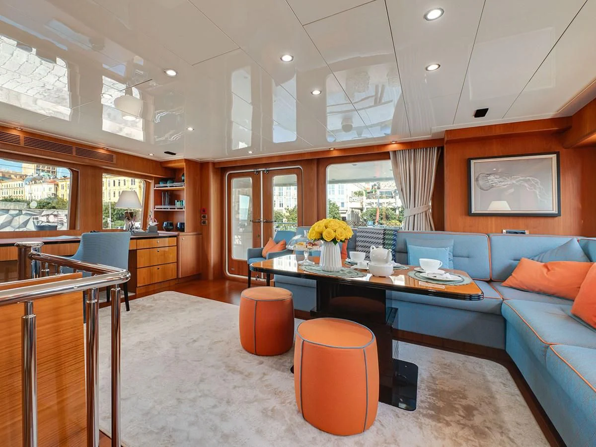 a living room with a couch and a table aboard MOCEAN Yacht for Sale