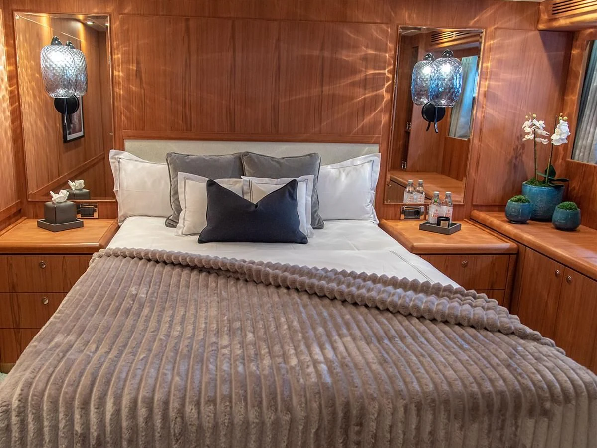 a bed with white sheets aboard MOCEAN Yacht for Sale