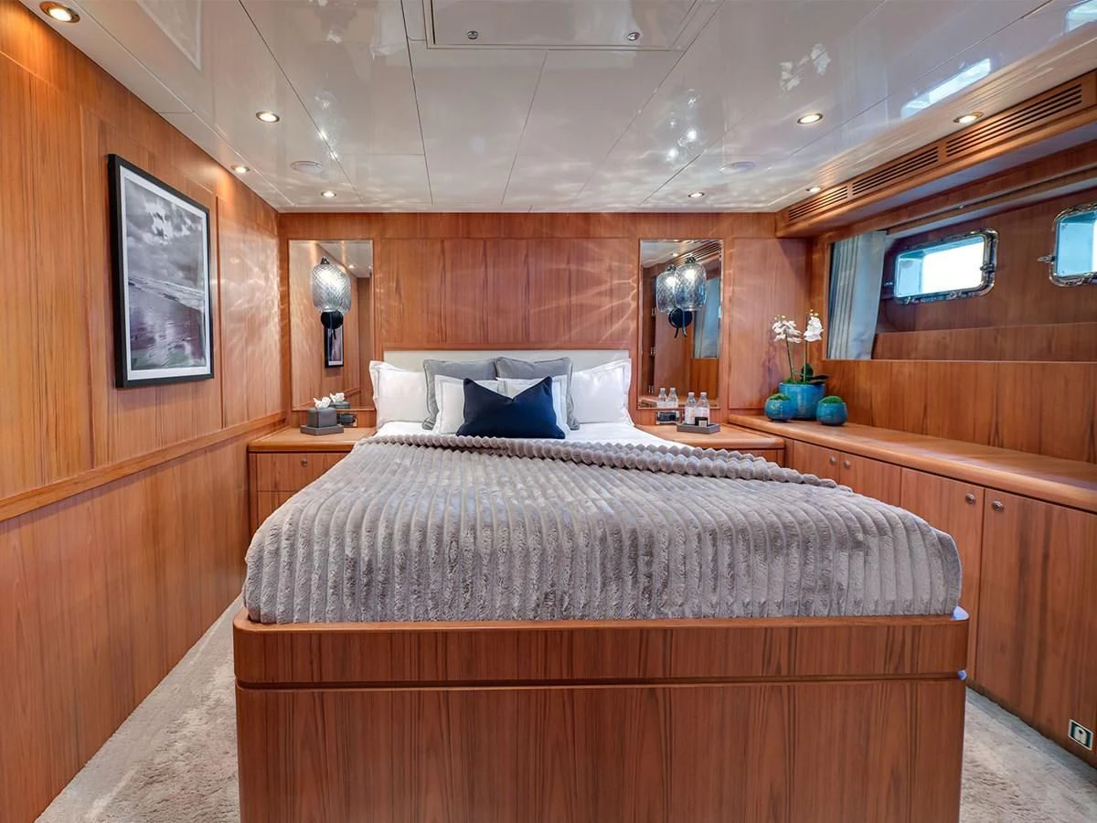 a bed with a white pillow aboard MOCEAN Yacht for Sale
