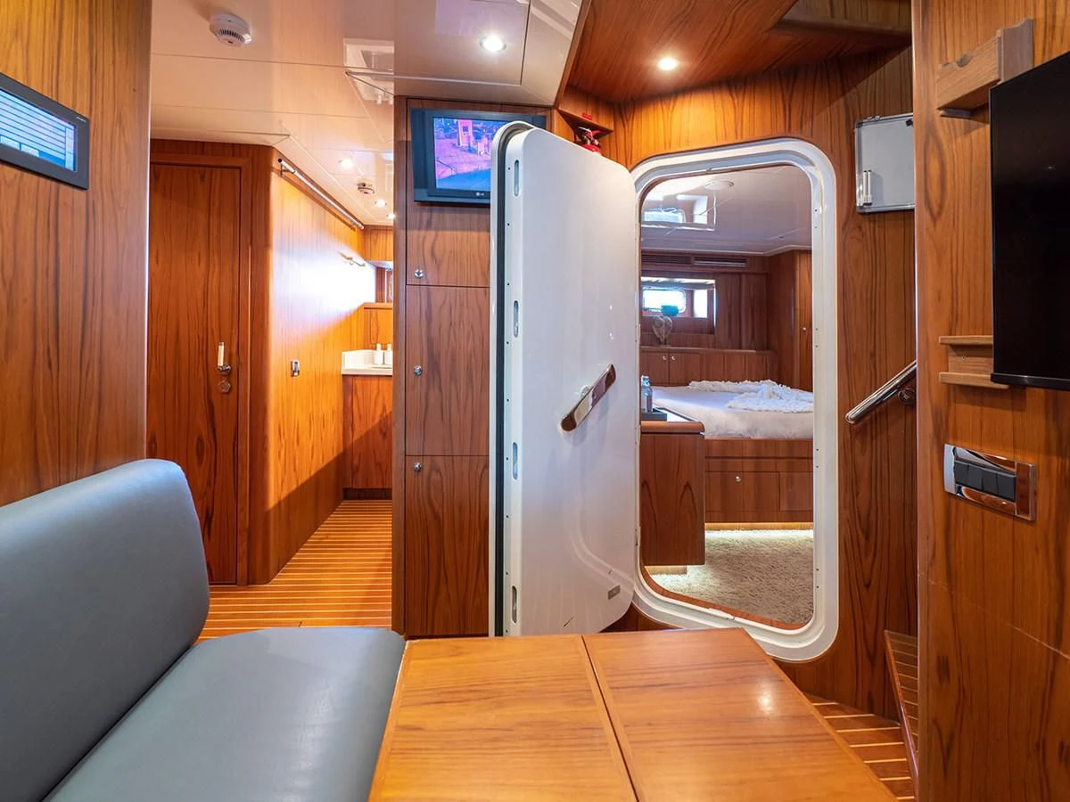 a room with a bed and a chair aboard MOCEAN Yacht for Sale