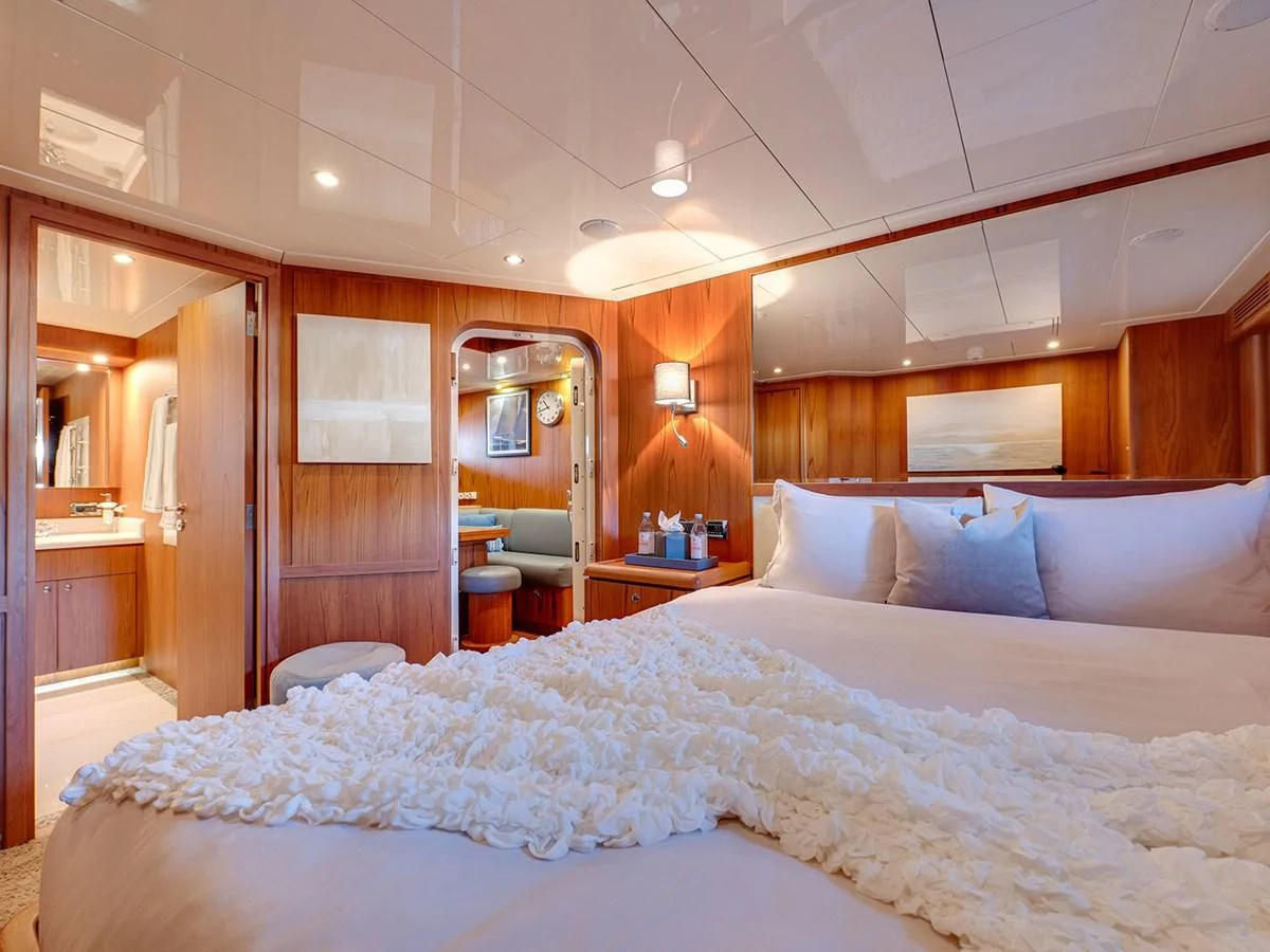 a bed with white sheets aboard MOCEAN Yacht for Sale