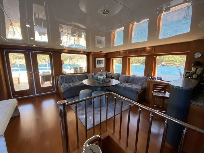 a large dining room with a large open window aboard MOCEAN Yacht for Sale
