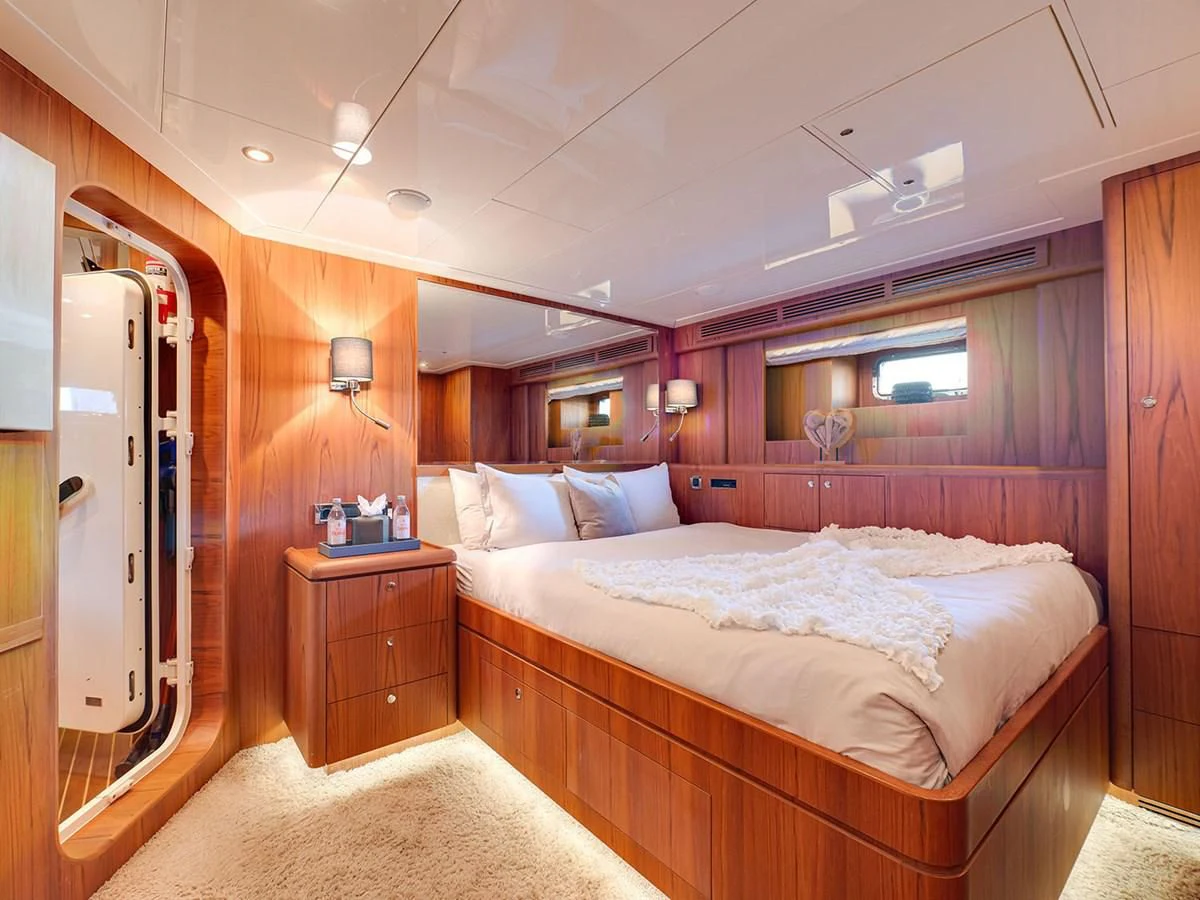 a bedroom with a bed and a mirror aboard MOCEAN Yacht for Sale