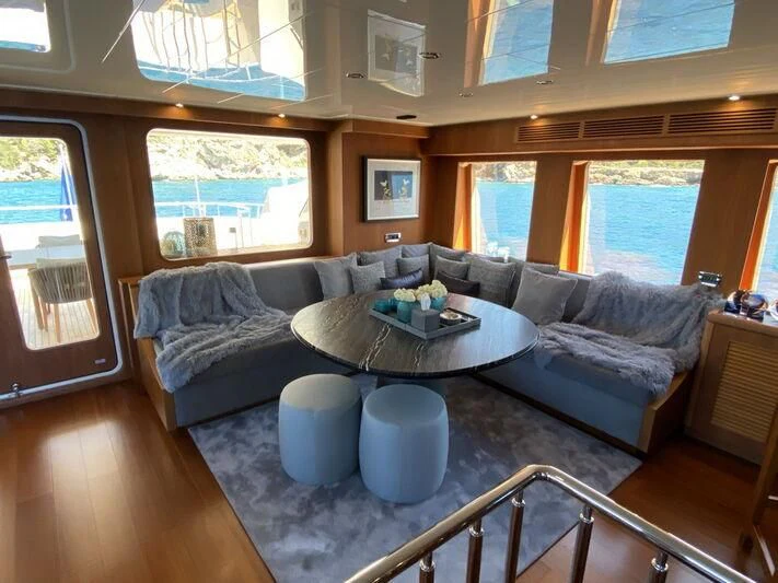 a living room with a couch and a coffee table aboard MOCEAN Yacht for Sale