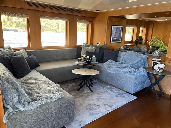 a living room with a couch and a coffee table aboard MOCEAN Yacht for Sale