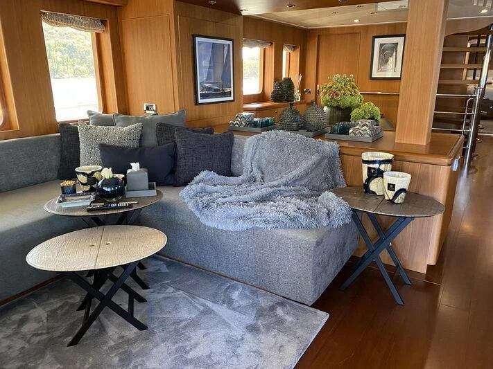 a living room with a large couch aboard MOCEAN Yacht for Sale