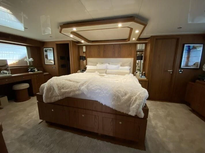 a bedroom with a bed and a tv aboard MOCEAN Yacht for Sale