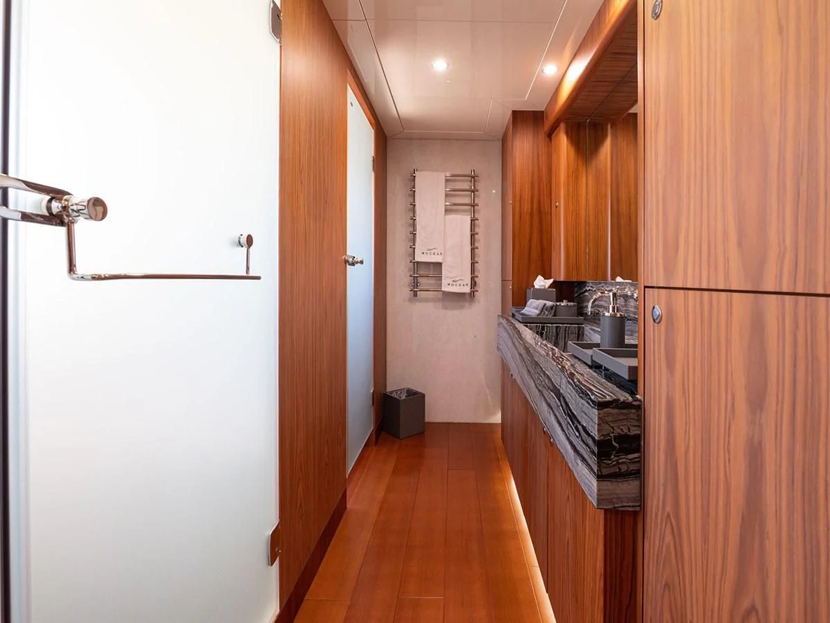 a kitchen with wooden cabinets aboard MOCEAN Yacht for Sale