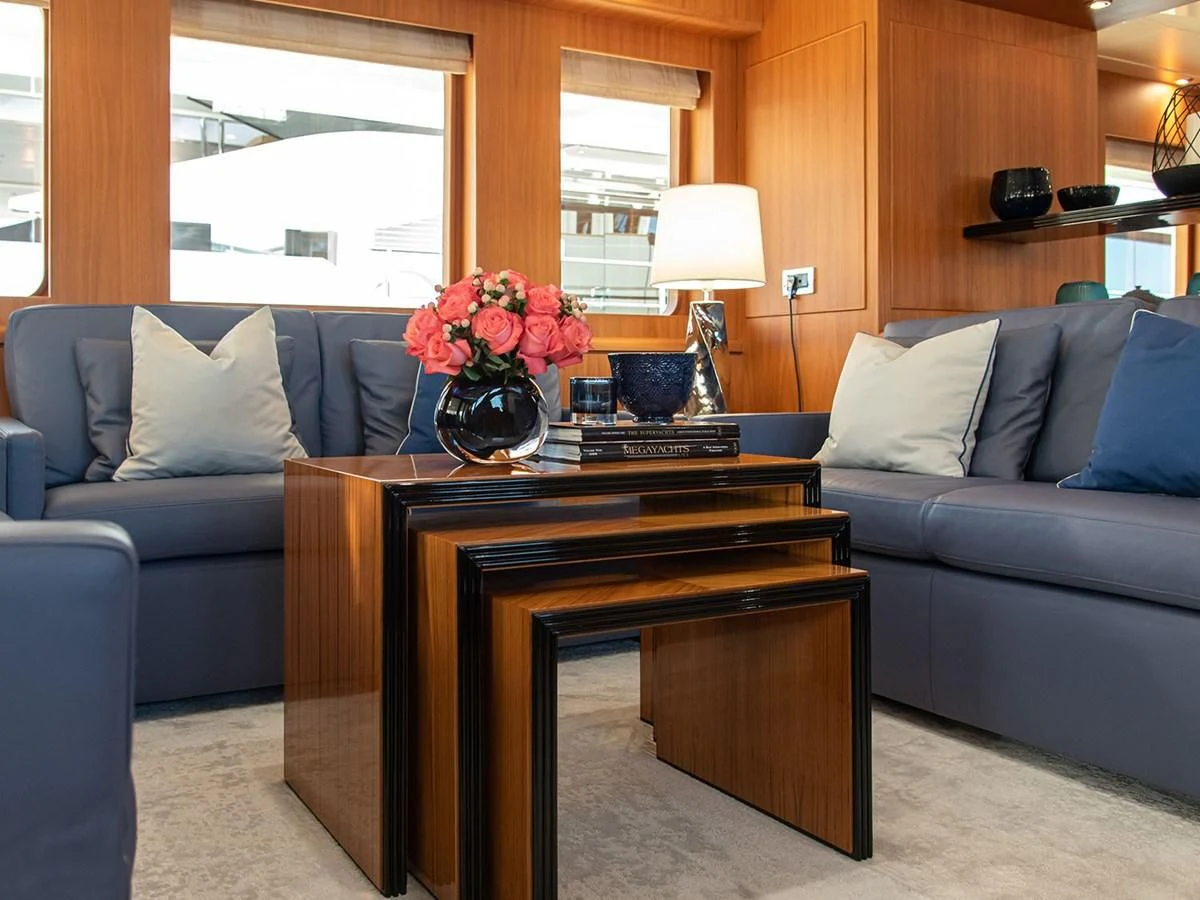 a living room with a couch and a coffee table aboard MOCEAN Yacht for Sale