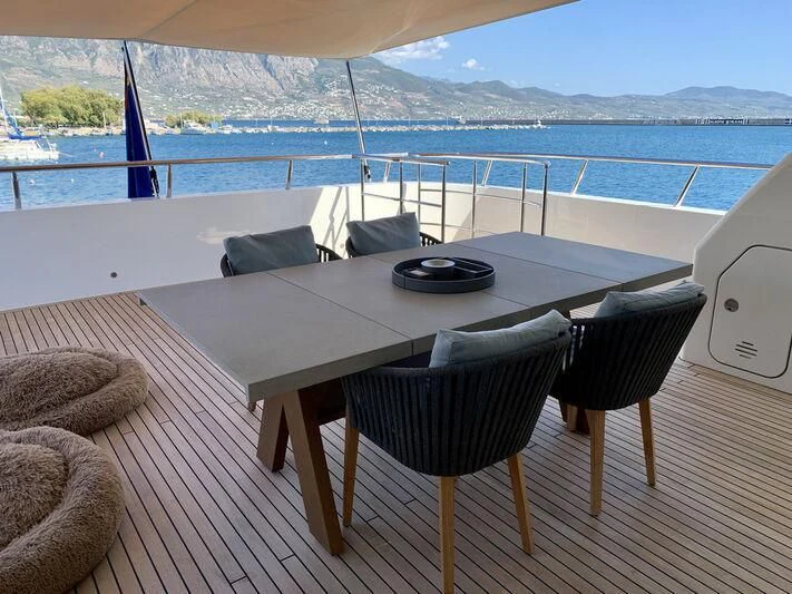 a table on a deck overlooking the ocean aboard MOCEAN Yacht for Sale