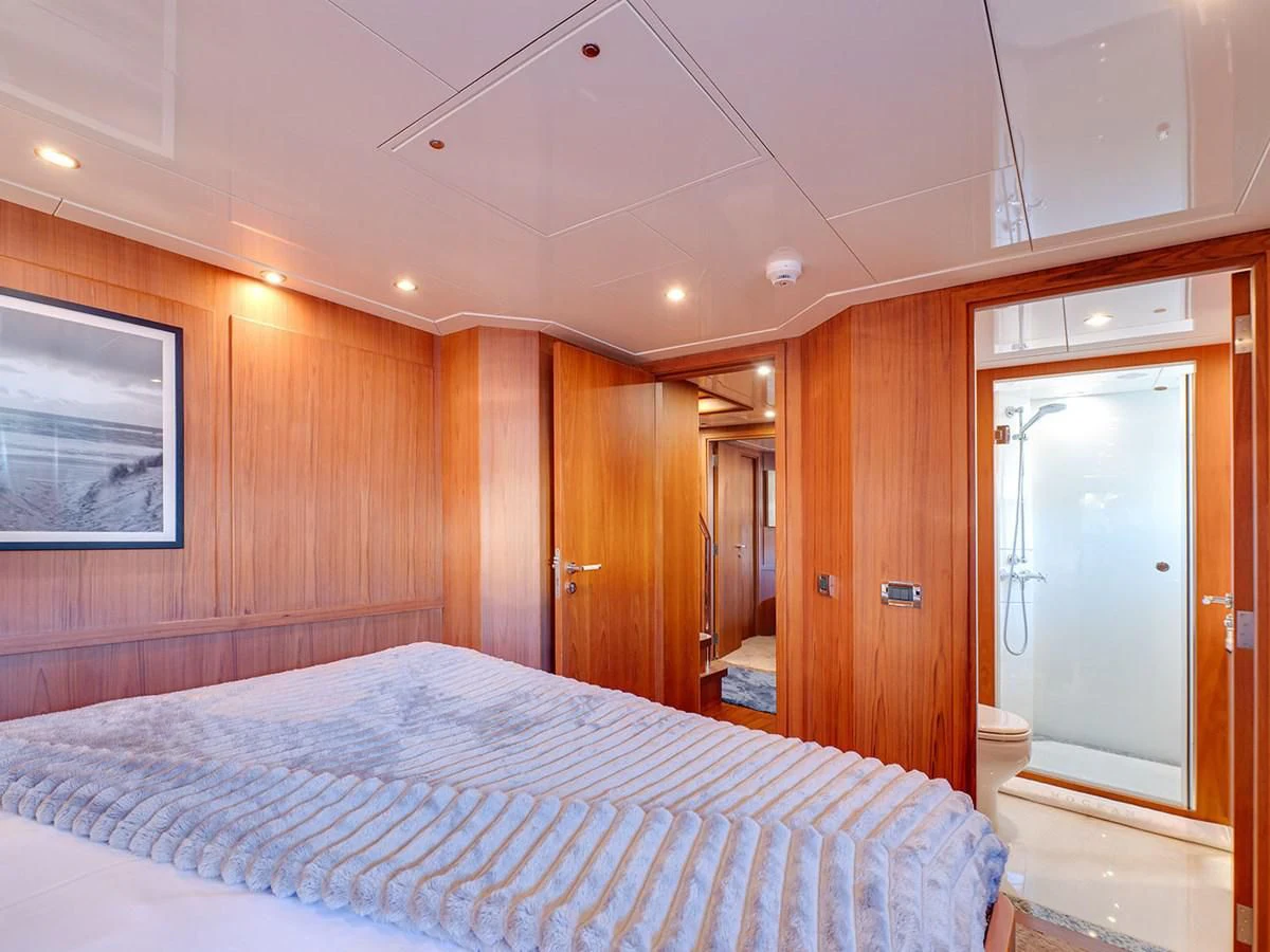 a bedroom with wood walls aboard MOCEAN Yacht for Sale