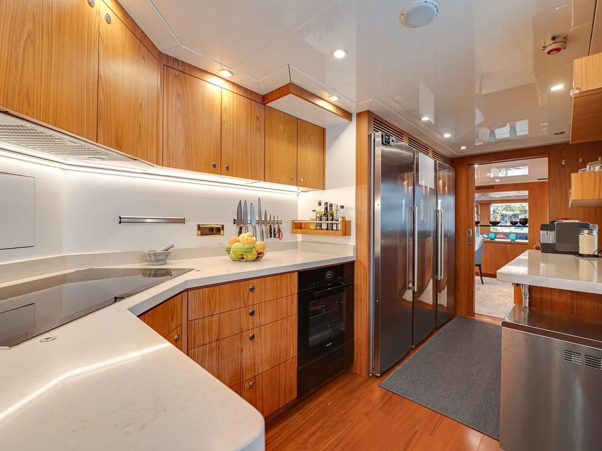 a kitchen with wooden cabinets aboard MOCEAN Yacht for Sale
