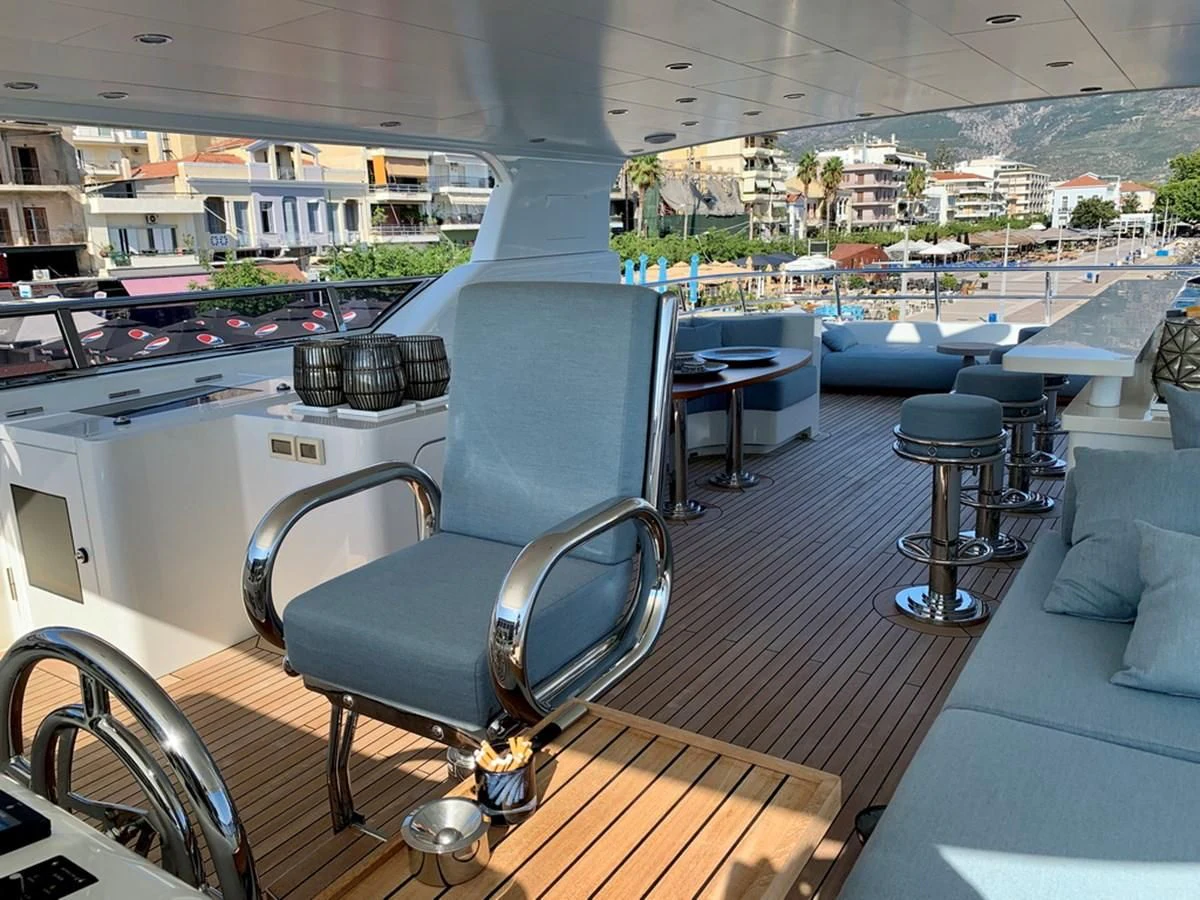 a large room with a bar and a large window aboard MOCEAN Yacht for Sale