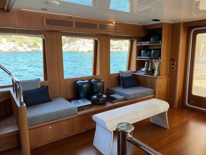 a living room with a couch and a coffee table aboard MOCEAN Yacht for Sale