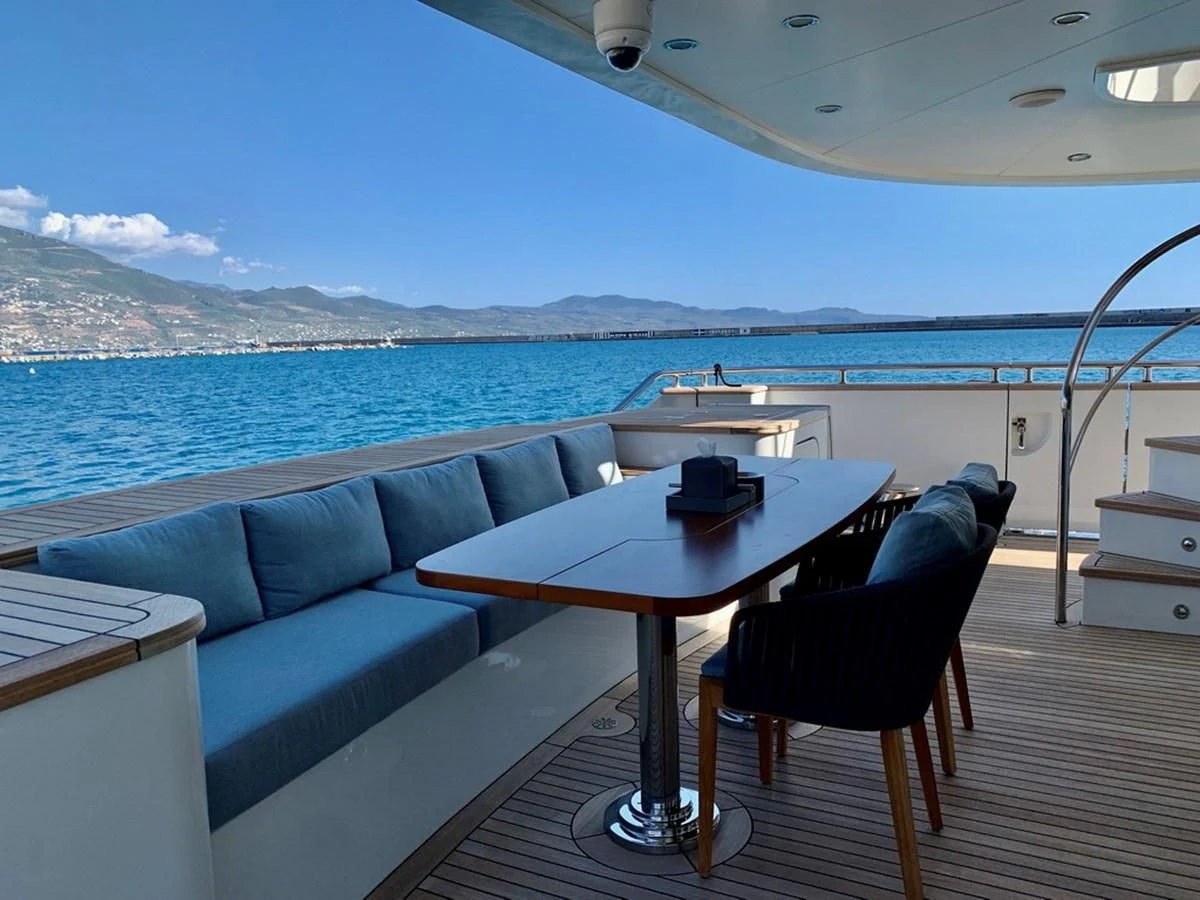 a table and chairs on a deck overlooking a large body of water aboard MOCEAN Yacht for Sale