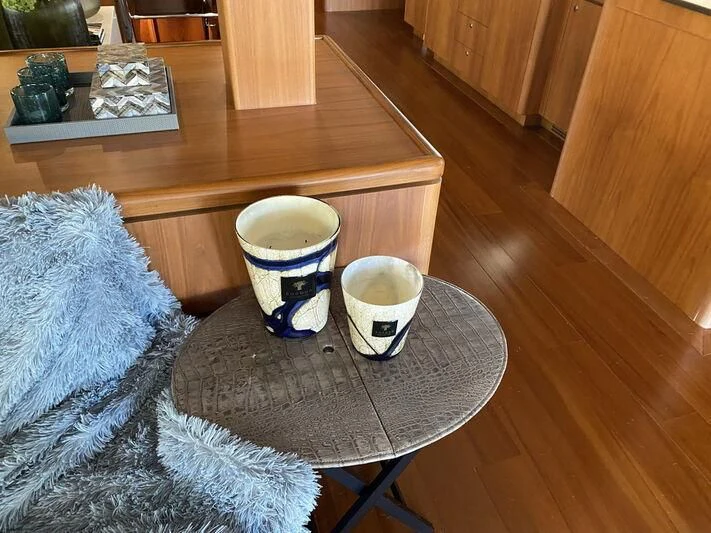 a coffee cup on a rug aboard MOCEAN Yacht for Sale