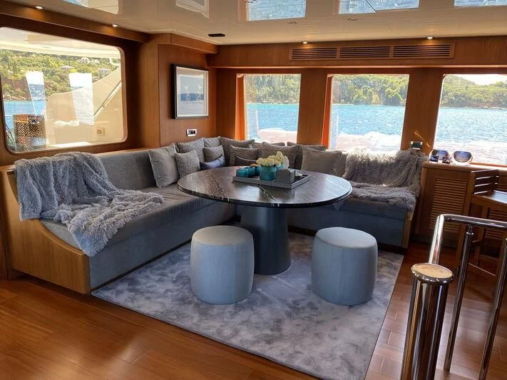 a living room with a couch and a table aboard MOCEAN Yacht for Sale