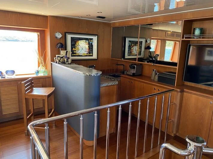 a kitchen with a bar and a table aboard MOCEAN Yacht for Sale