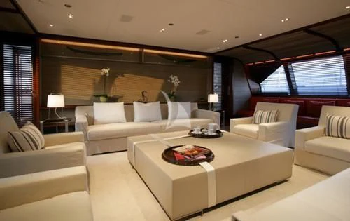a living room with a large white table and couches aboard ROSEHEARTY Yacht for Charter