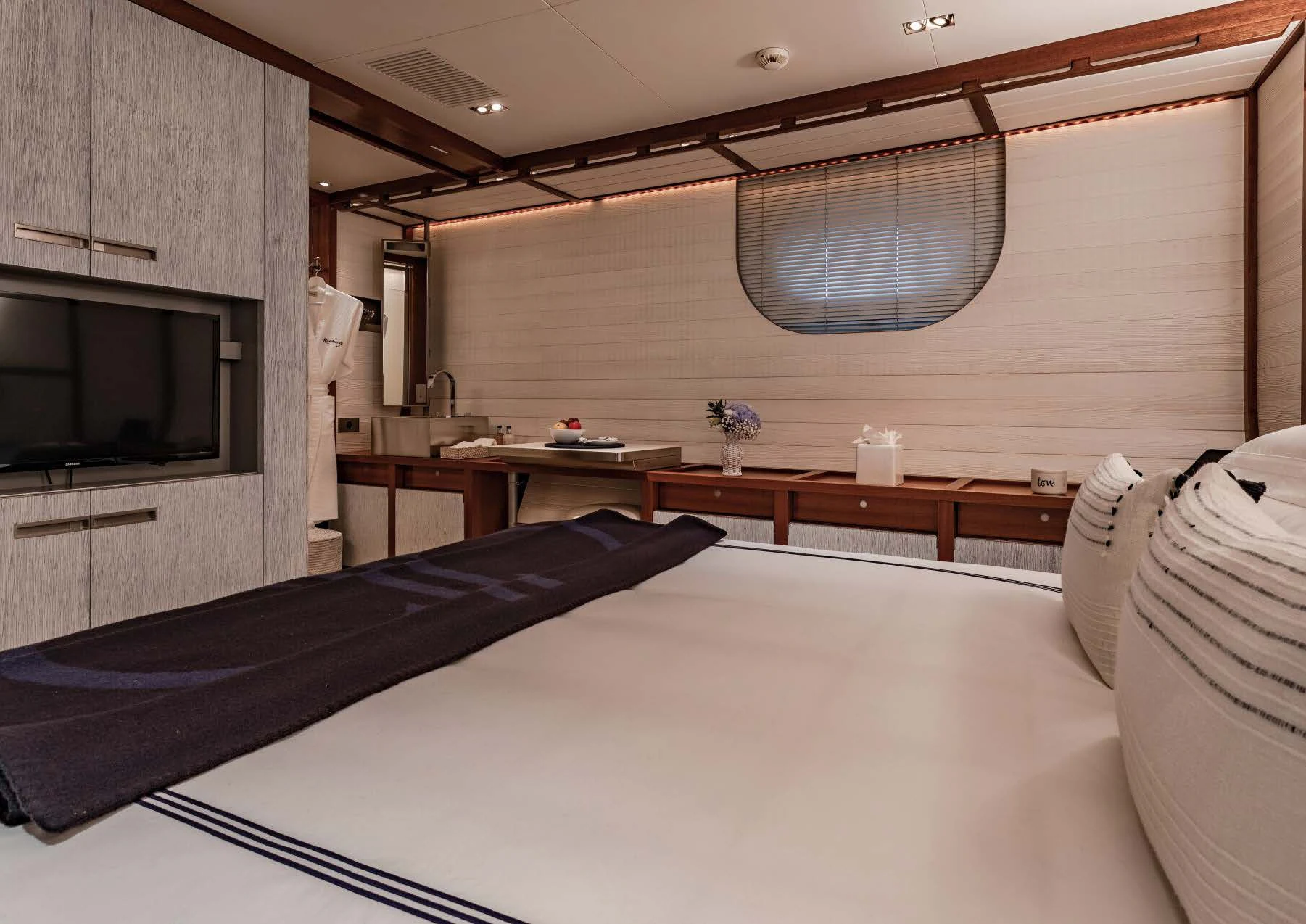 a room with a bed and a television aboard ROSEHEARTY Yacht for Charter