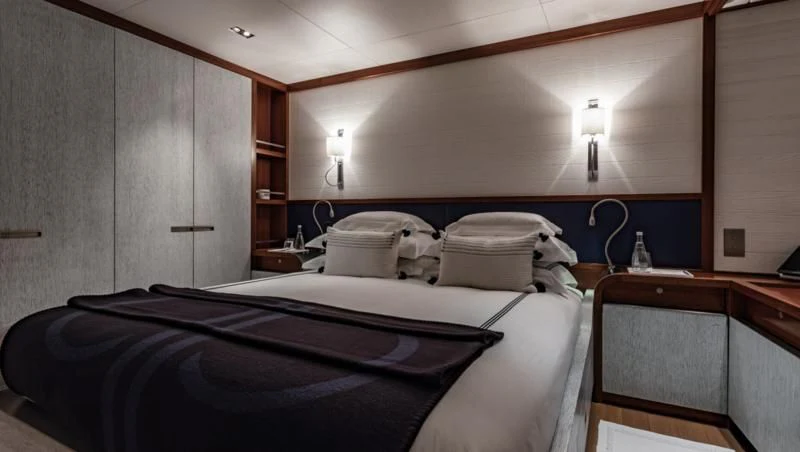a room with a bed and a desk aboard ROSEHEARTY Yacht for Charter