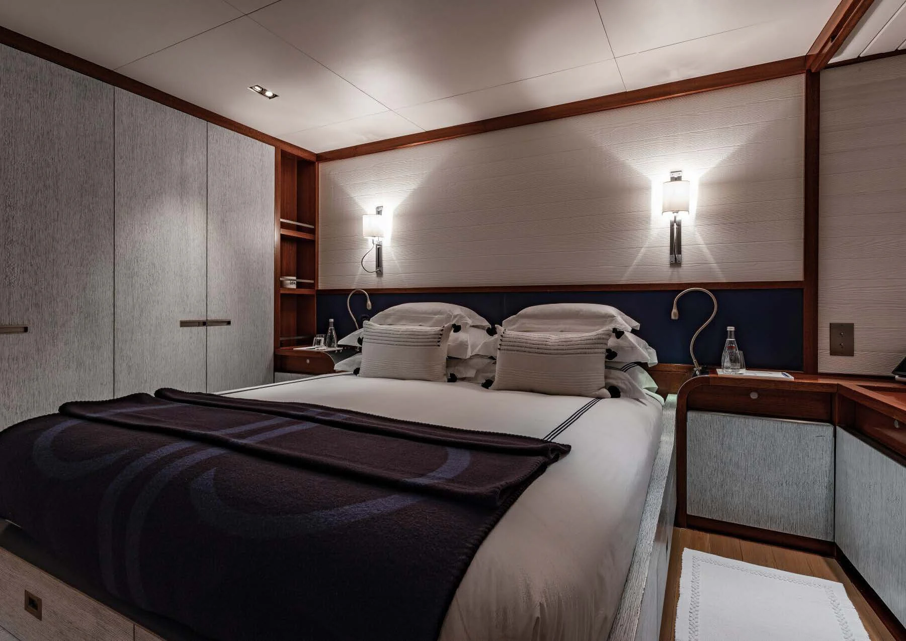 a room with a bed and a desk aboard ROSEHEARTY Yacht for Charter