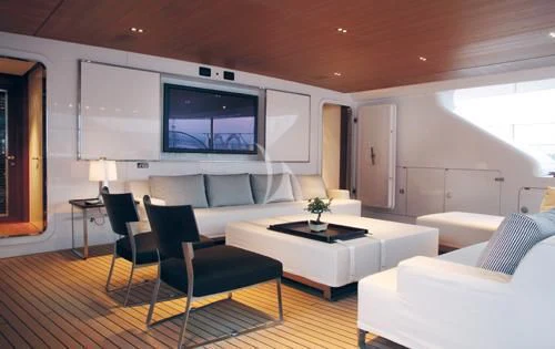 a living room with a large screen aboard ROSEHEARTY Yacht for Charter