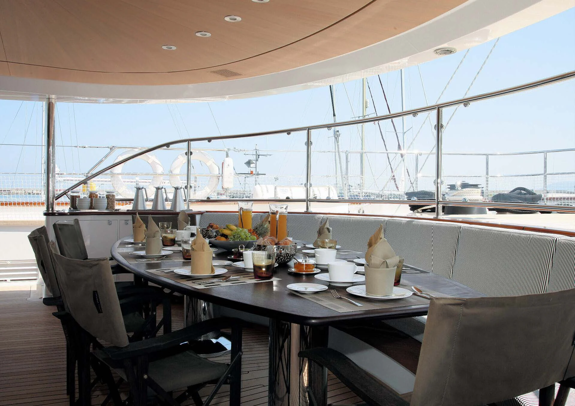 a table with chairs and a large window aboard ROSEHEARTY Yacht for Charter