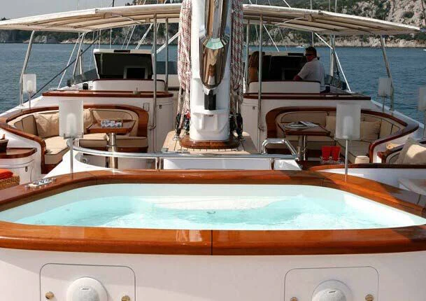 a boat with a person sitting on it aboard ROSEHEARTY Yacht for Charter