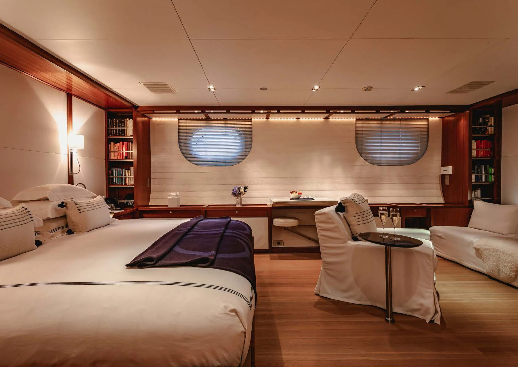 a room with a bed and a table aboard ROSEHEARTY Yacht for Charter