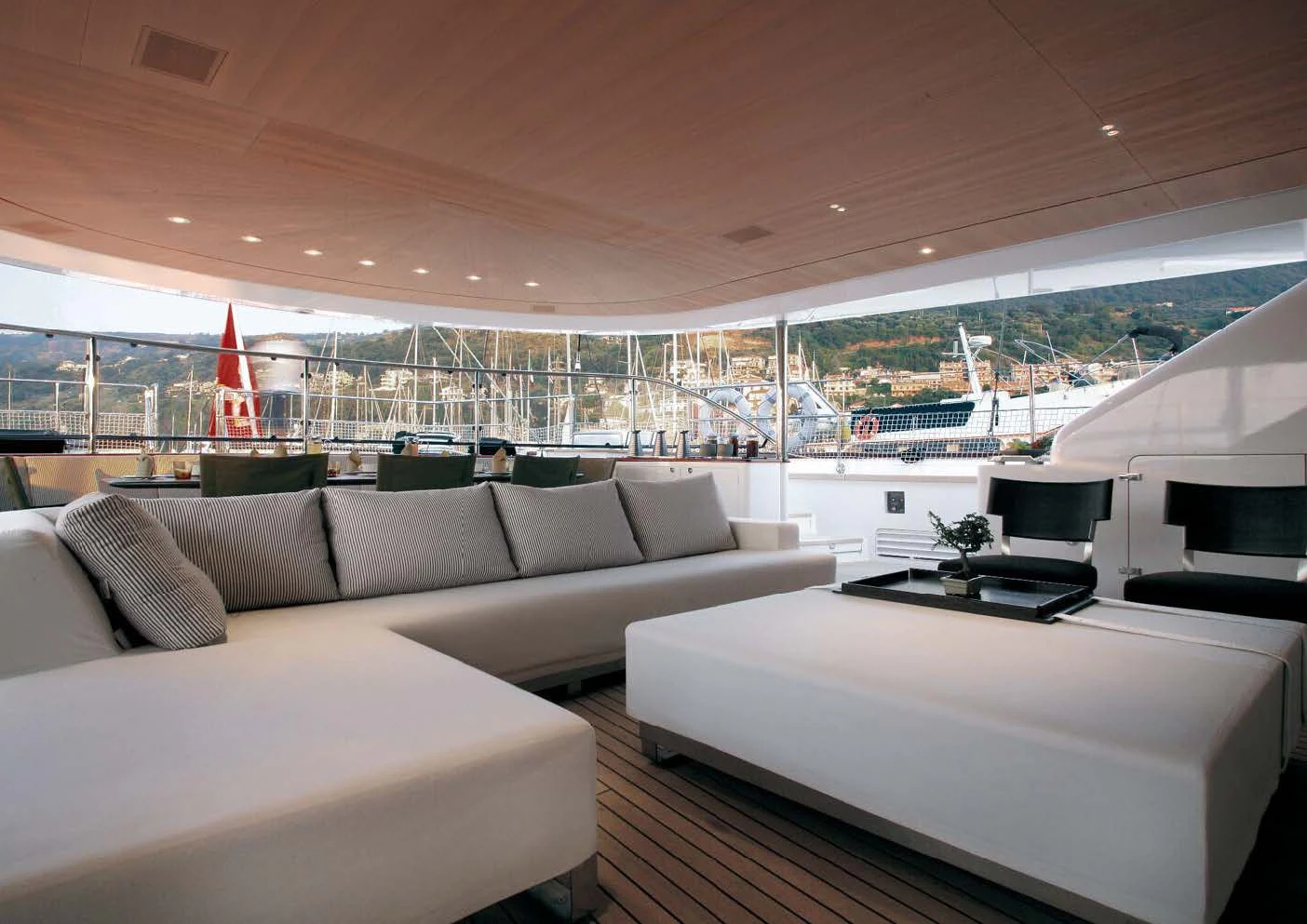 a living room with a large white sofa and a large window aboard ROSEHEARTY Yacht for Charter